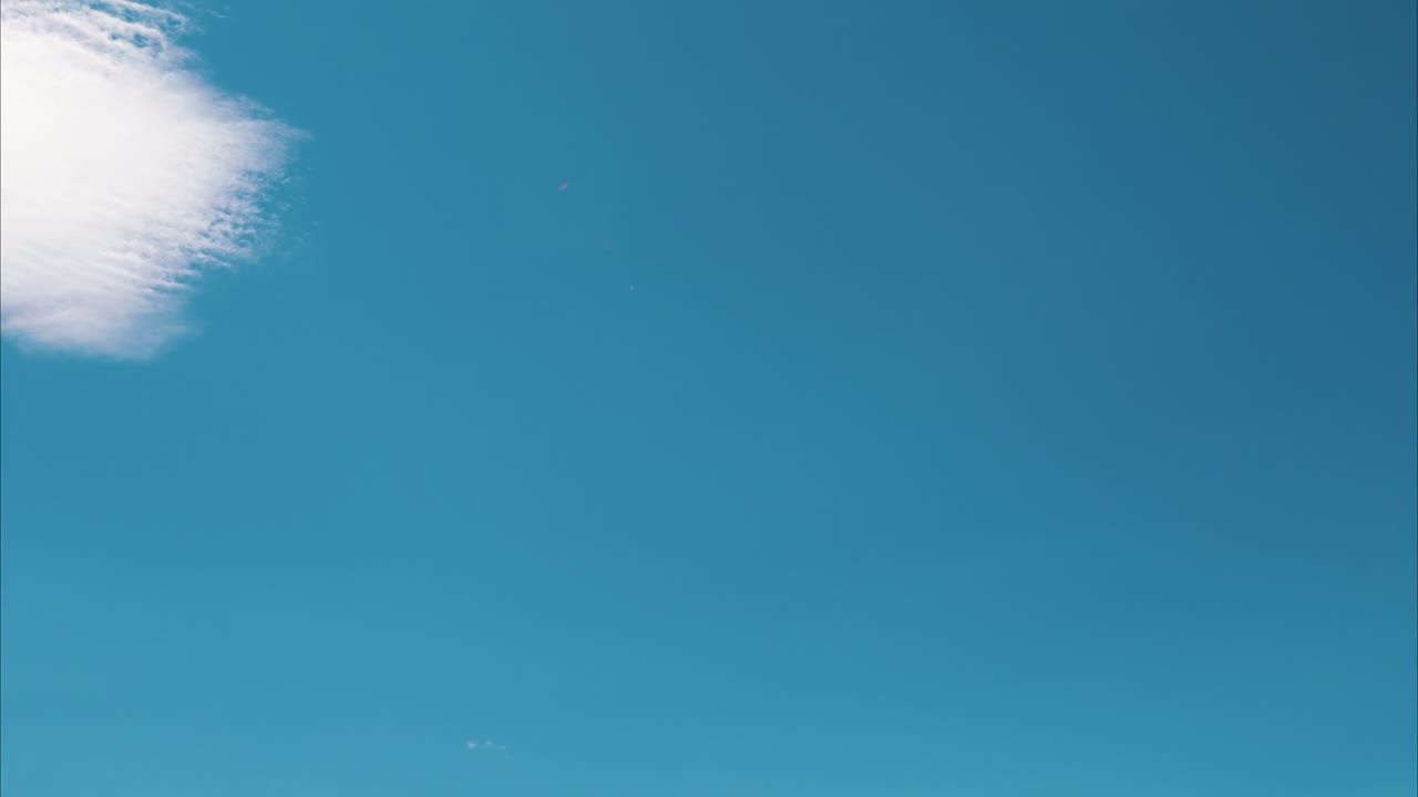 The iconic Matterhorn rises sharply against a vivid blue sky, surrounded by rugged alpine terrain and glaciers, tilt down shot