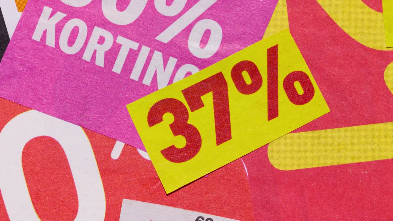 Close-up stop motion of sale stickers and percent signs, retail advertising loop