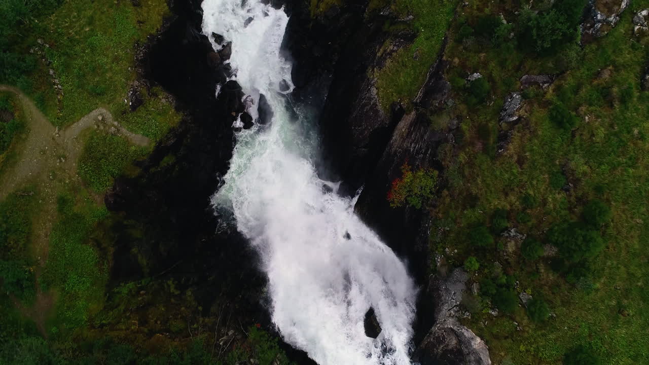 Aerial Bird's Eye View following Låtefossen Downstream revealing a Bridge with a Car passing over