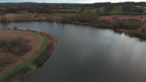 an aerial shot of a river surrounded by trees and greenery
