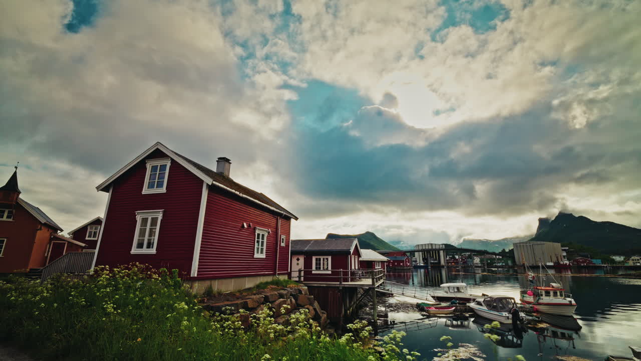Walking around the famous red fishermen cabins in the Lofoten islands, Norway. View of local town of Svolvaer.