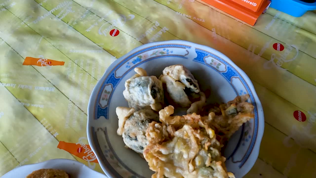 Red bean soup and other Indonesian food specialties on table, handheld