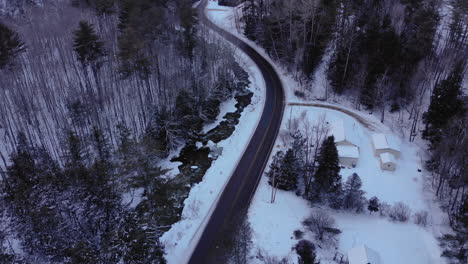 Small-winding-road-in-snowy-mountains-of-Vermont-during-sunset