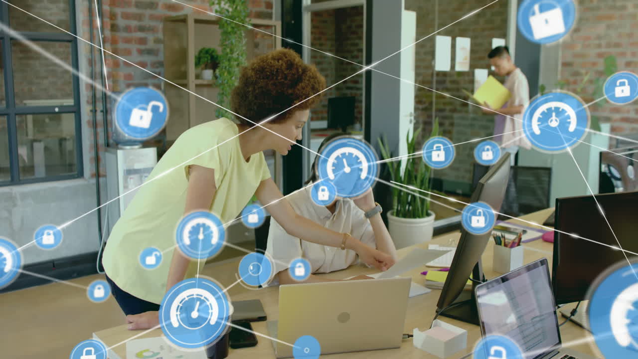 Animation of network of connections with icons over diverse female colleagues using laptop in office