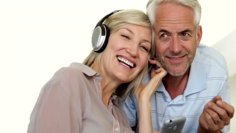 Cute-mature-couple-listening-to-music-together