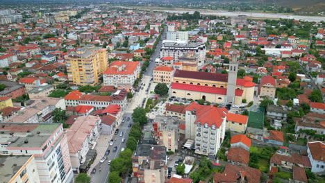 Aerial-drone-top-down-shot-over-city-buildings-in-Shkodra,-also-known-as-Shkoder-or-Scutari-in-northwestern-Albania-at-daytime