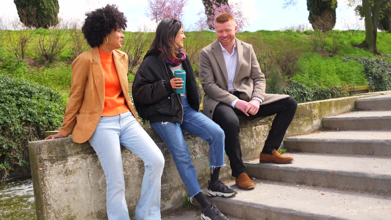 Three Friends Chatting Outdoors