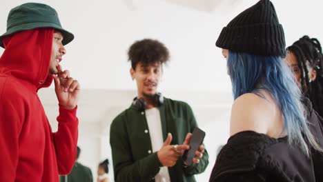 happy diverse male and female dancers talking in dance studio, slow motion