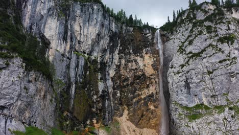 Austrian-Alps-waterfall-storm-approaches-aerial-orbit