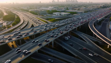 aerial view of highway traffic and city skyline