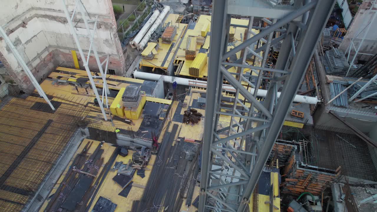 Big metal crane at building site. Aerial view of construction project in progress