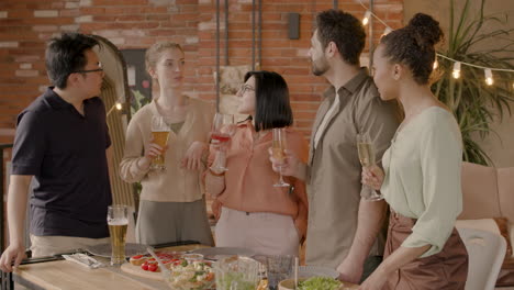 a nice multiethnic group of friends conversing at a dinner party