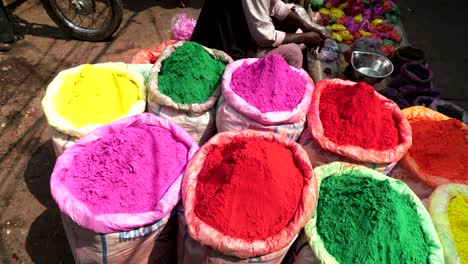 pan of large bags of powder for holi at the spice market of chandni chowk