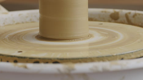 Close-up-shot-of-removing-a-vase-from-a-potters-wheel-with-different-techniques