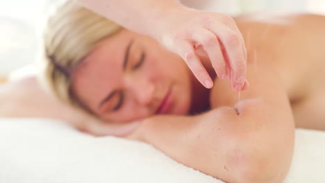 hand of massage therapist inserting acupuncture