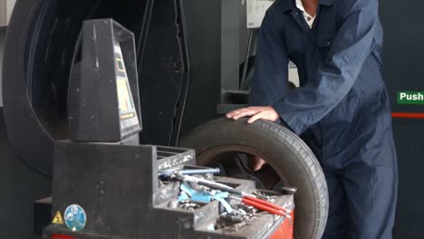 mechanic working on a tire