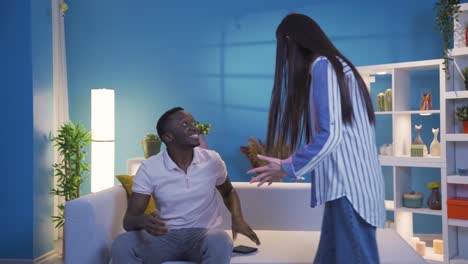 Young-woman-surprises-African-boyfriend-or-husband,-giving-good-news.
