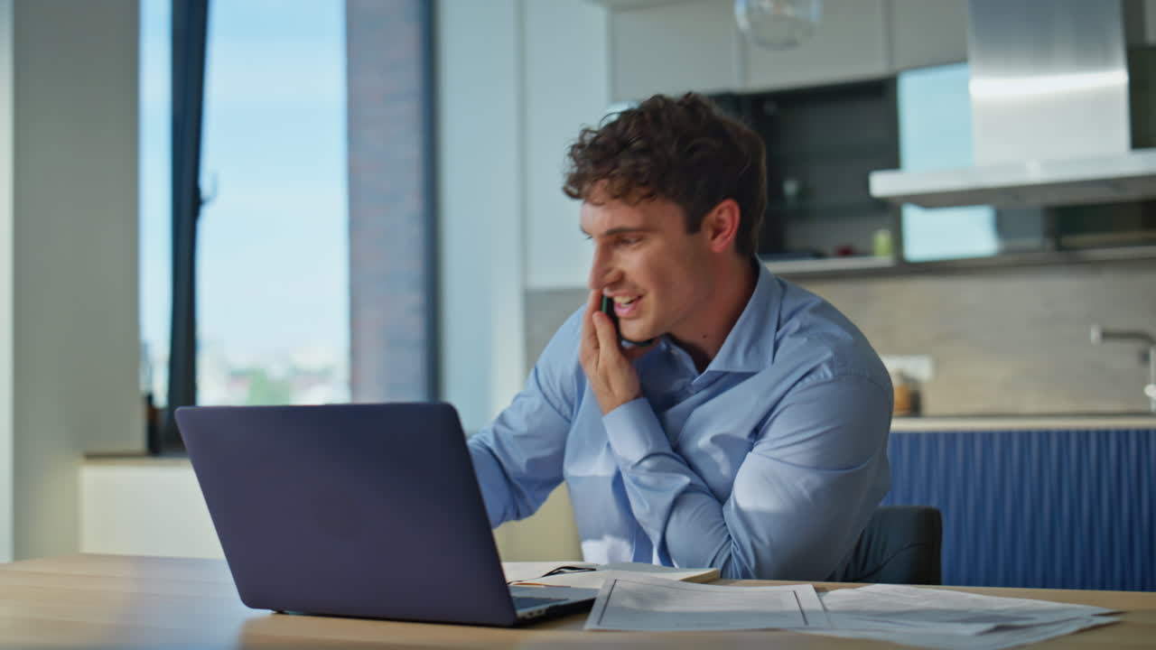 Calling employee drinking coffee working on laptop in remote office closeup