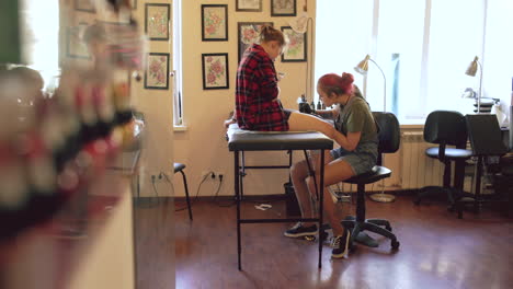 teenage girls getting a tattoo