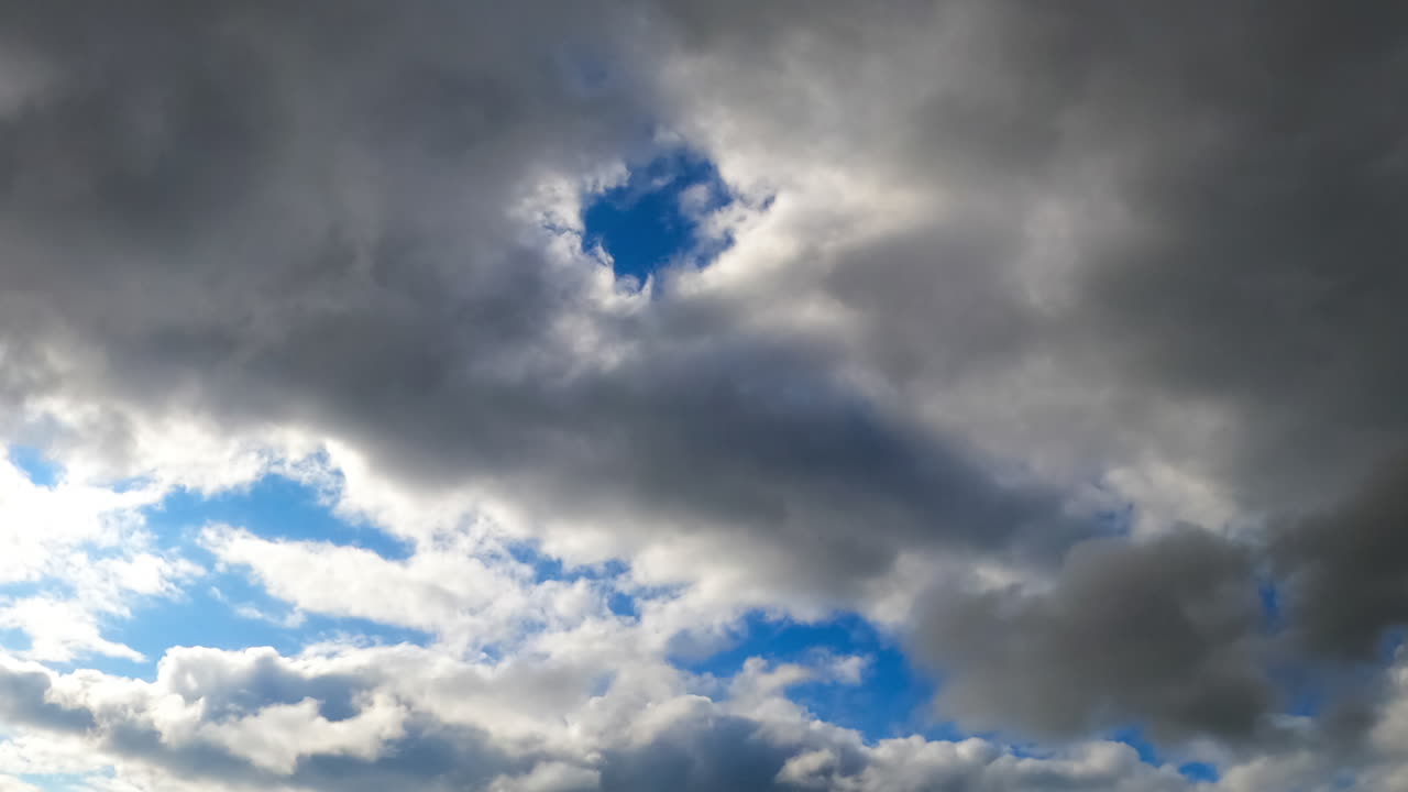 Timelapse clouds moving across the sky. Time-lapse captures shifting clouds as they drift across a vibrant sky, revealing changing weather patterns and light