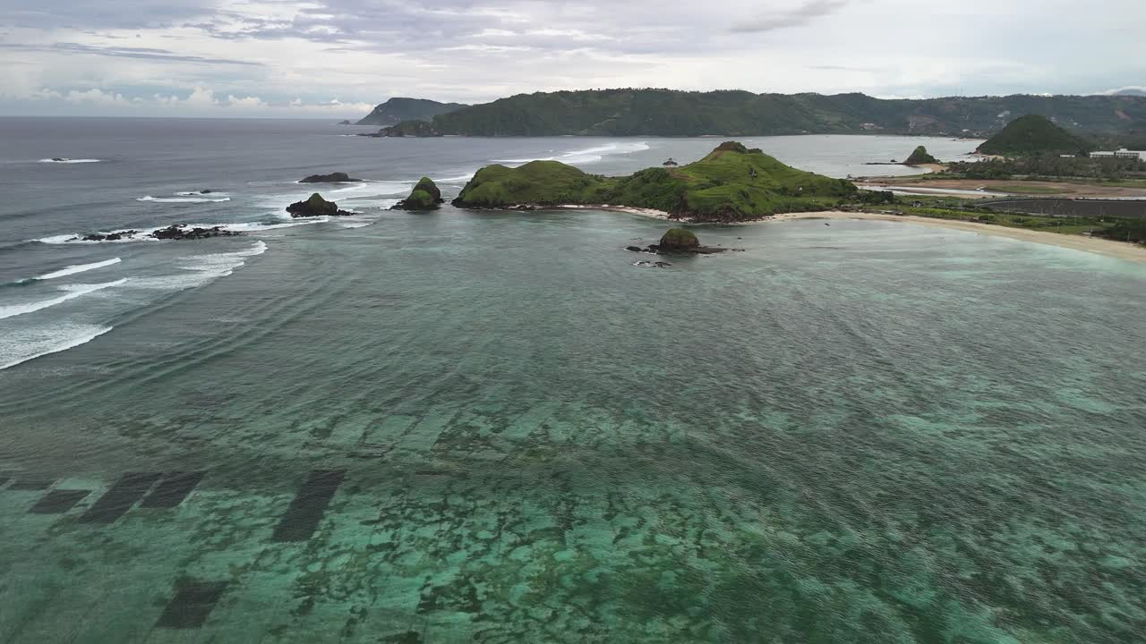Flyover shallow coral bay off Seger Beach on tropical coast of Lombok
