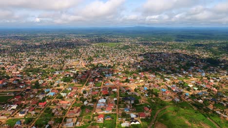 aerial birds eye view flying over housing neighborhood at day, wide angle