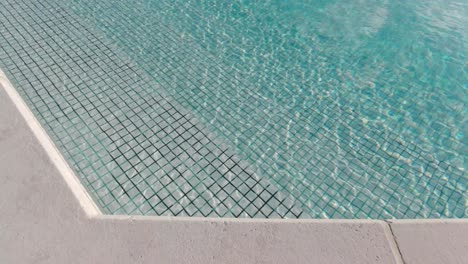 swimming pool with ripple on the water surface on a sunny day in slow motion