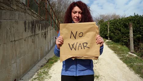 anti war demonstration, girl walks forward with a protest sign in hand, peace concept, medium shot