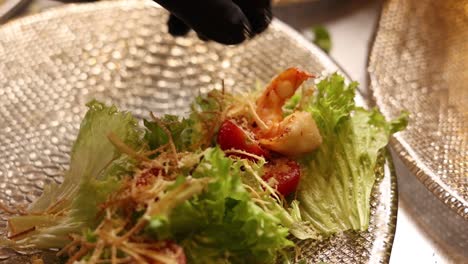 chef preparing a caesar salad with shrimp