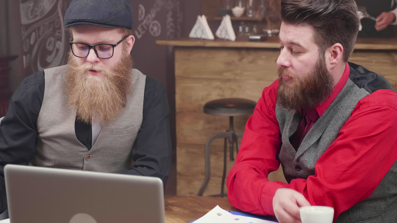 Men discussing business in a cafe