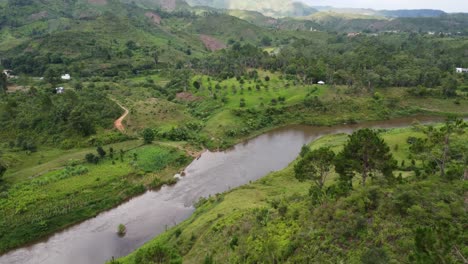 beautiful drone shot of malagasy nature including a river, jungle, mountains and a protected grassland