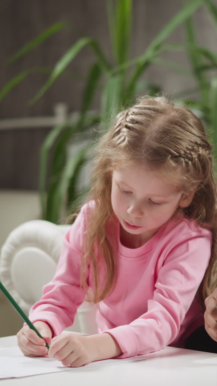 Attentive black man teacher sits with little children students doing homework at private English tuition with native speaker at home slow motion