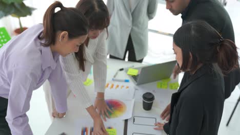 business people proficiently discuss work project on meeting table