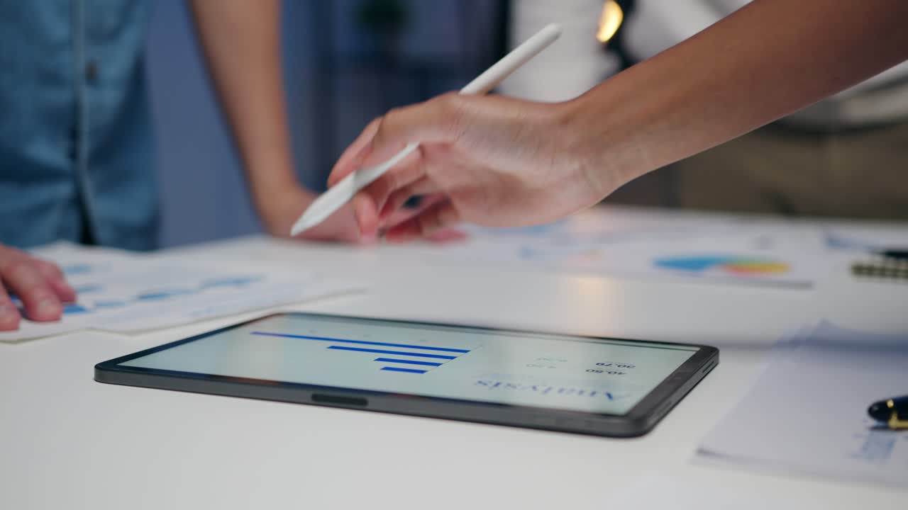 Businesspeople meeting brainstorming ideas about new paperwork project colleagues working together planning success strategy enjoy teamwork in small modern night office.