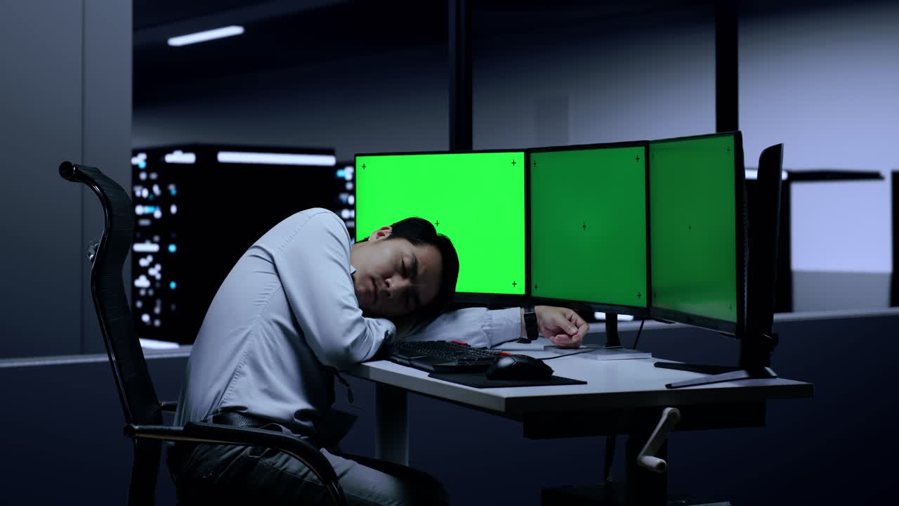 Tired worker sleeping at the night shift in server room