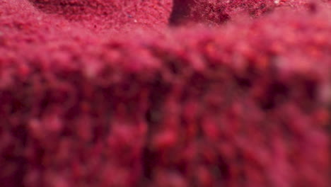 macro close up of a bright, pink, wool sweater