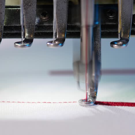 textile industry at garment manufacturer. sewing machine embroiders various companies and engravings