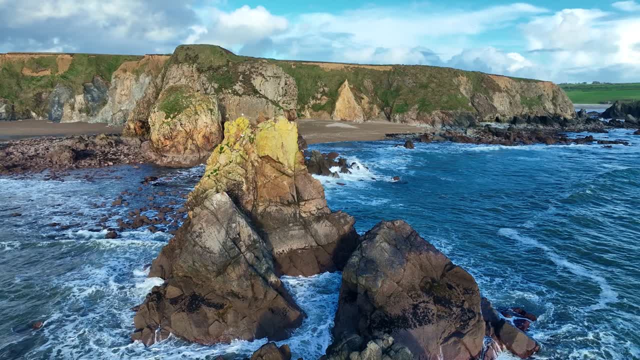 Ireland Epic Locations drone flying over sea stack to secluded beach Benvoy Copper Coast Waterford in autumn