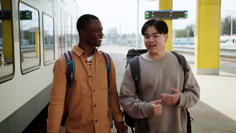 Friends-walking-at-the-train-station