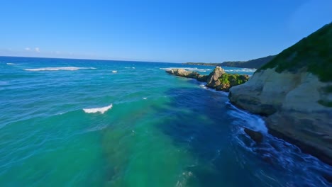 aerial drone fpv scene over rocky coast of el breton beach in dominican republic