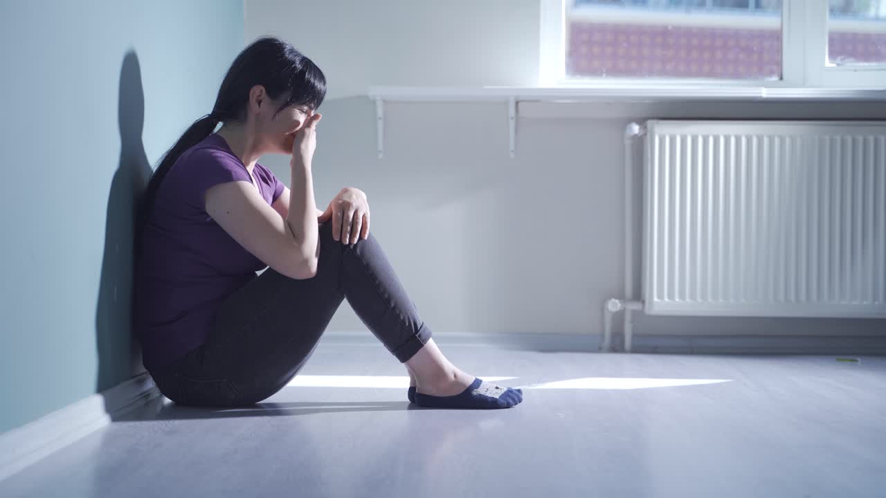 Sad woman crying at home.