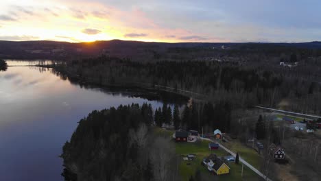 drone rising and filming the sunset by a lake in sweden