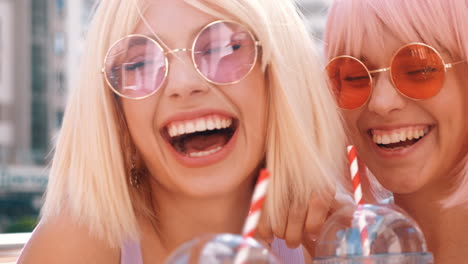 two happy friends enjoying a drink