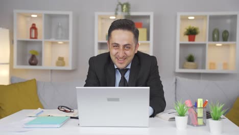 Home-office-worker-man-waving-at-camera.