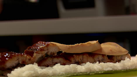 preparing unagi and foie gras sushi