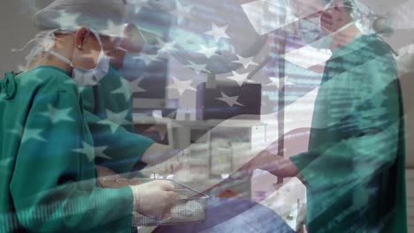 Animation-of-flag-of-usa-waving-over-surgeons-in-operating-theatre