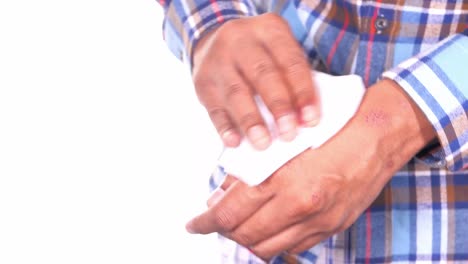 person wiping hands with a tissue