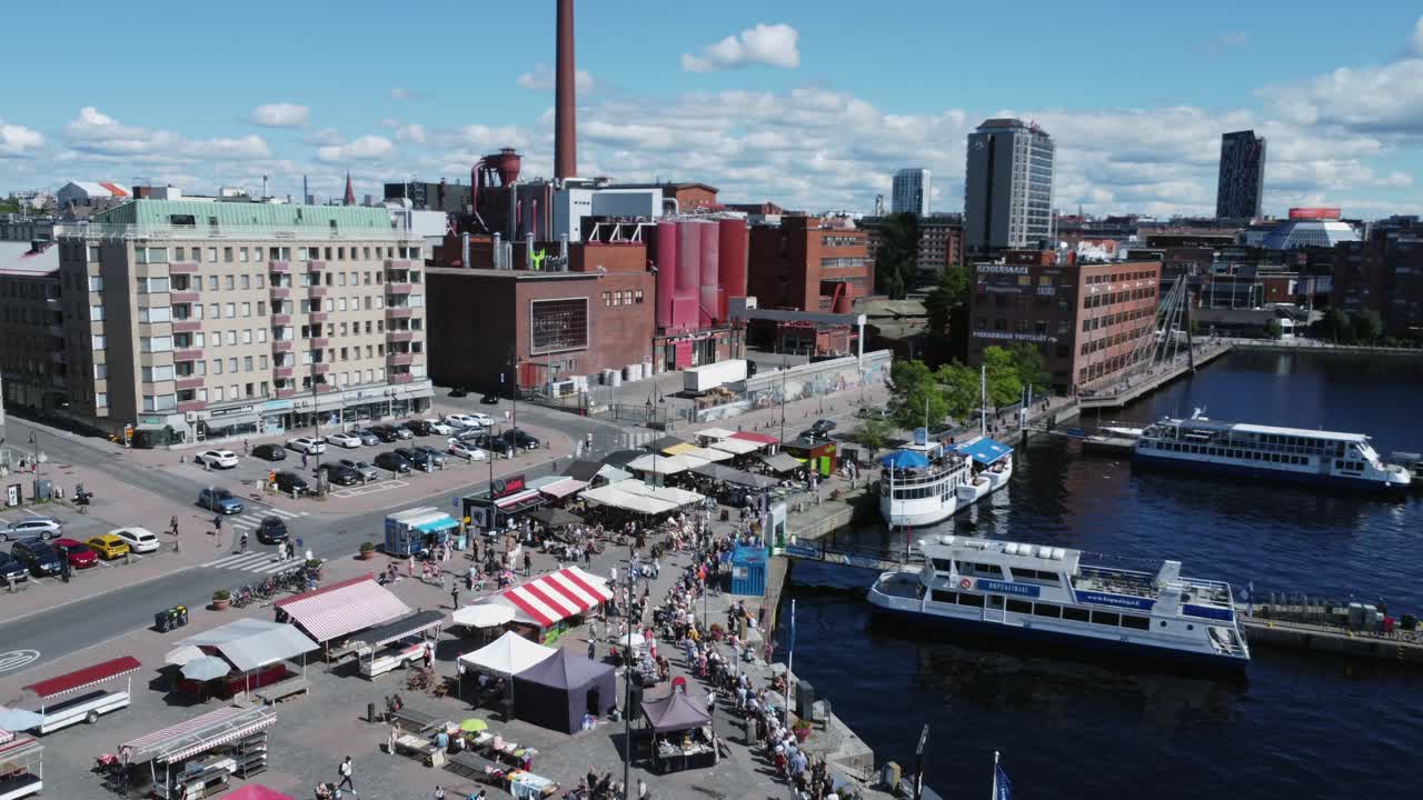 People crowd beautiful Laukontori waterfront of Tampere, Finland
