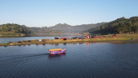 Aerial-view-of-the-charm-of-the-Sermo-reservoir-Yogyakarta-Indonesia,-boats-traveling-between-mountains-and-plains-for-camping