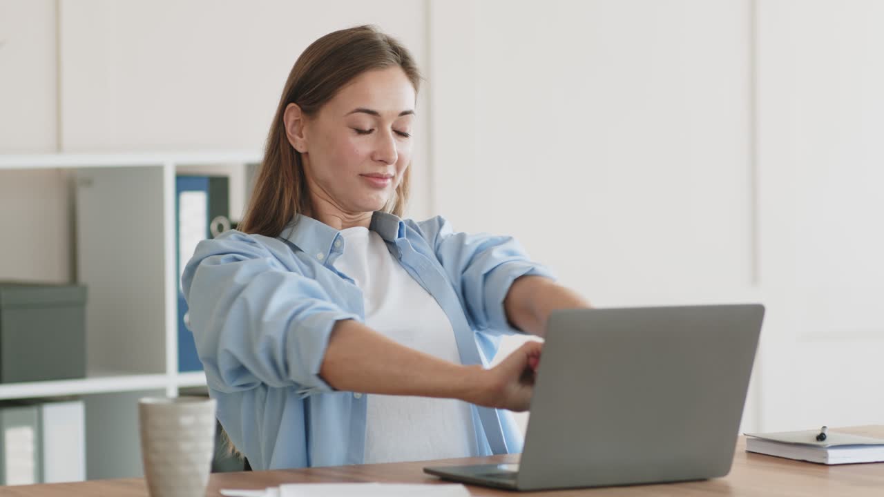 Woman Stretching at Her Desk